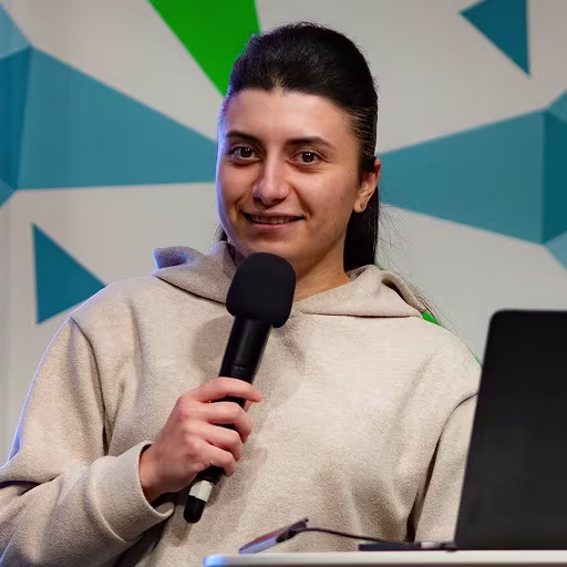Djamile Abdullaeva, founder of User First, speaking at a design conference